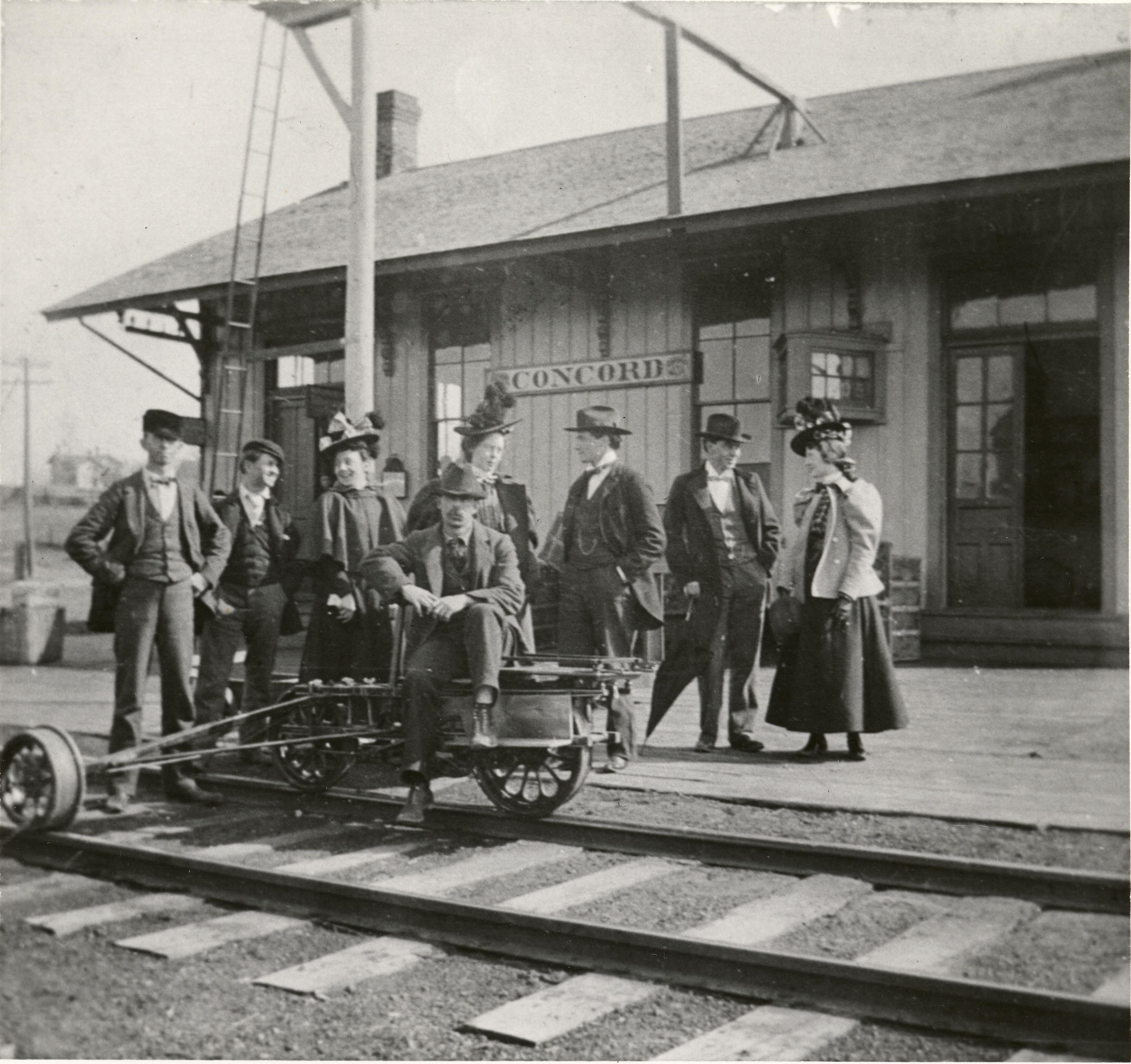 A group of people stand outside a depot in Concorde, MI