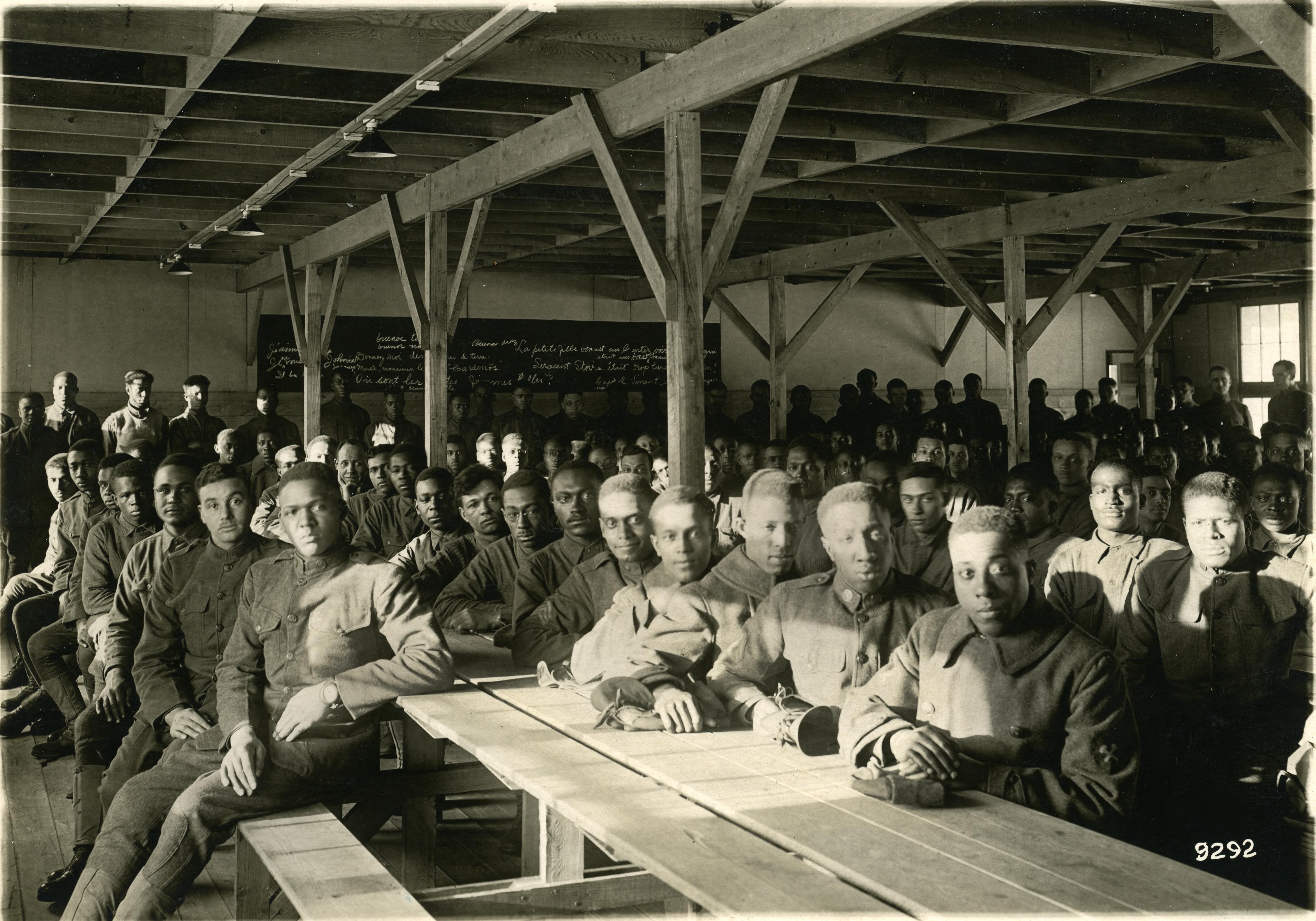 Soldiers seated at long tables at Fort Custer (known then as Camp Custer)