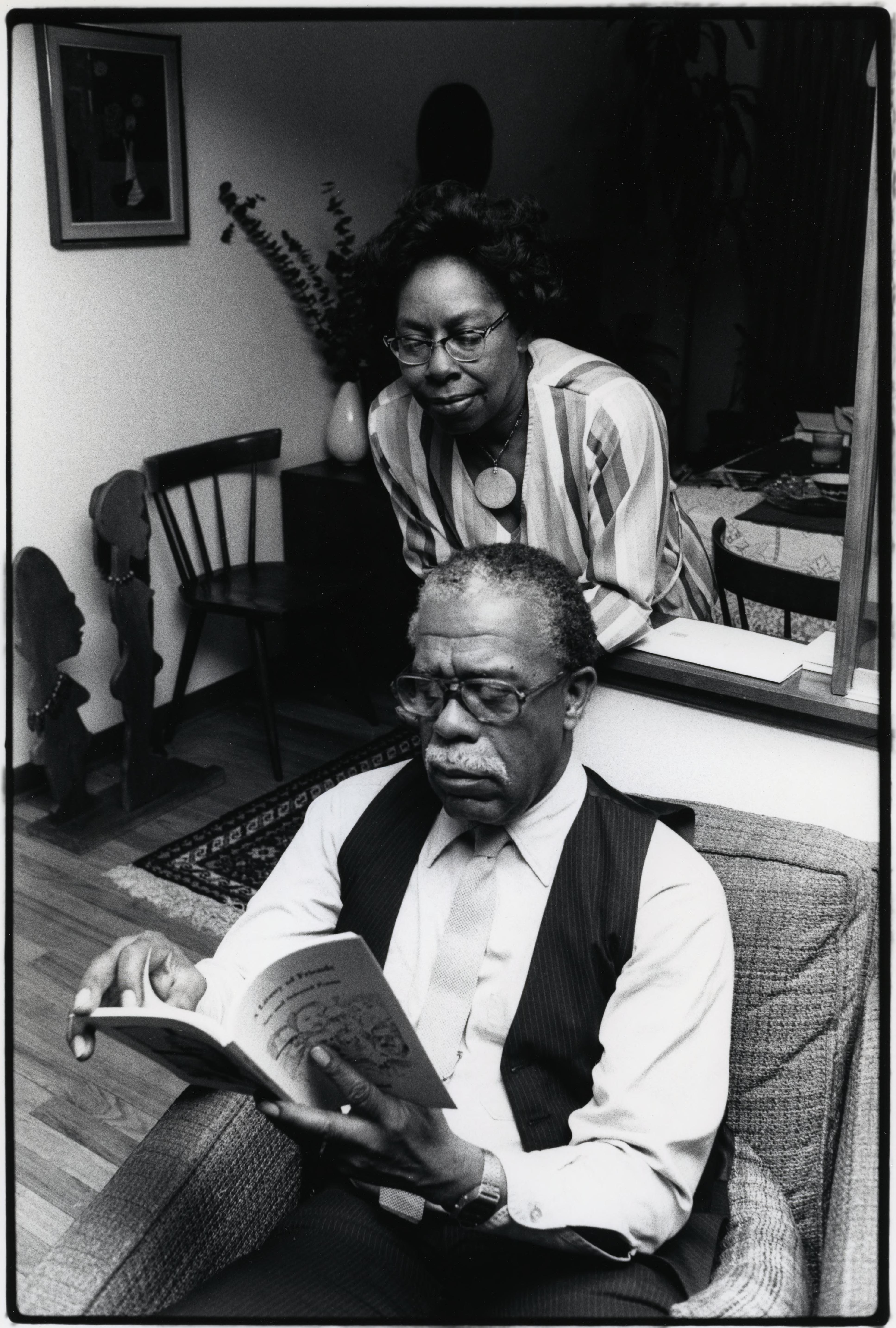 Poet Dudley Randall reading a book